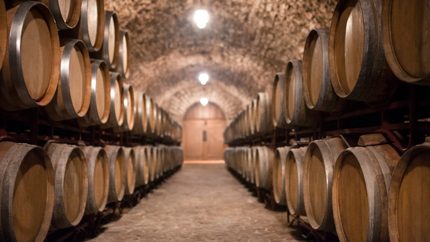 A row of wine barrels at a winery.